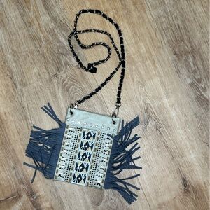 Leather fringe and grommet crossbody purse. Removable/changeable chain strap.